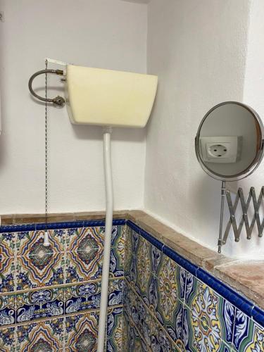 a bathroom with a sink and a mirror on the wall at Casa Nora in Iznate