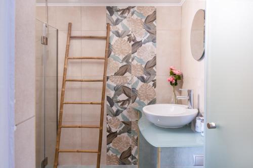 a bathroom with a sink and a mirror at Gorgona 1 in Loutra