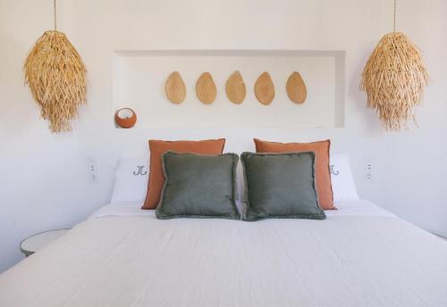 a bedroom with a white bed with two pillows at Villa Torre in Jávea