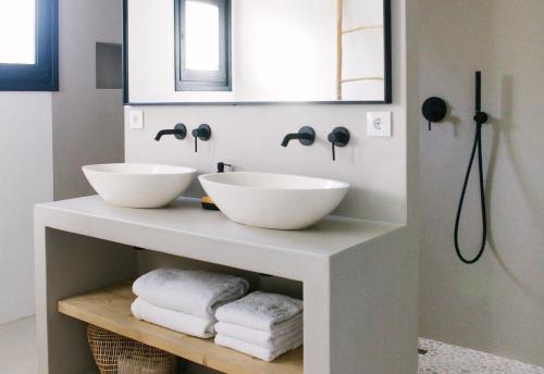 a bathroom with two white bowls on a vanity at Villa Torre in Jávea