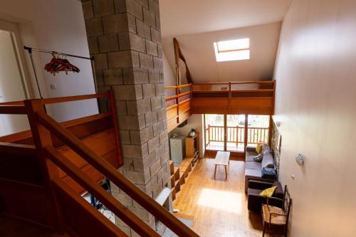 an overhead view of a living room with a stone wall at le gite à Géo in Thoiry