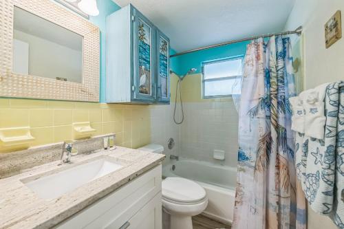 a bathroom with a sink and a toilet and a shower at pink peacock in Holmes Beach