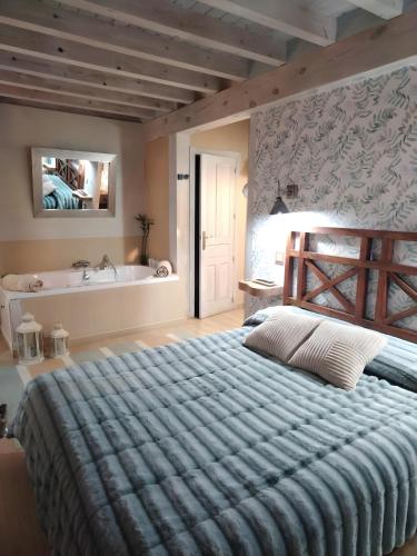 a bedroom with a large bed and a bath tub at Más Quimera in Gilgarcía