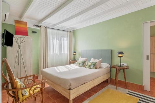 a bedroom with a bed and a tv in it at The Suite Villa in Playa Blanca