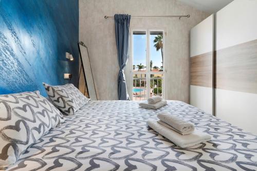 a bedroom with a large bed with towels on it at Bungalow Green Oasis in San Bartolomé