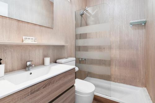 a bathroom with a toilet and a sink and a shower at Bungalow Green Oasis in San Bartolomé