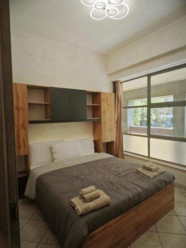 a bedroom with a large bed with two towels on it at DeMarchi in Biella