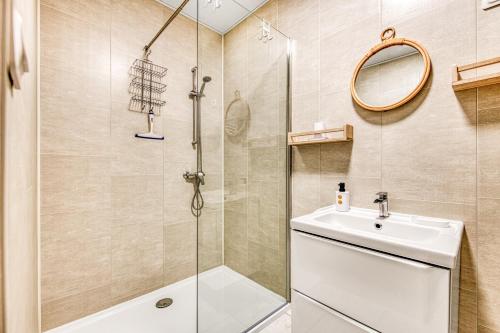a bathroom with a shower and a sink at Gite Barrail du Moulin in Bégadan