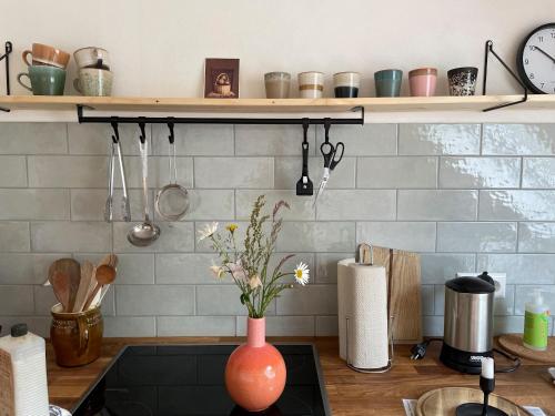 a kitchen counter with a vase on the stove at Gullerhof Ferienwohnung - Köpfle in Glottertal