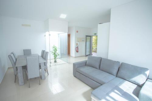 a living room with a couch and a table at Forest Village Exótic in Bolembre de Baixo