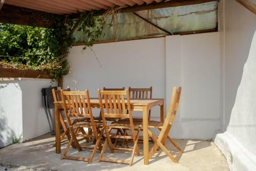 a wooden table and chairs on a patio at Forest Village Exótic in Bolembre de Baixo