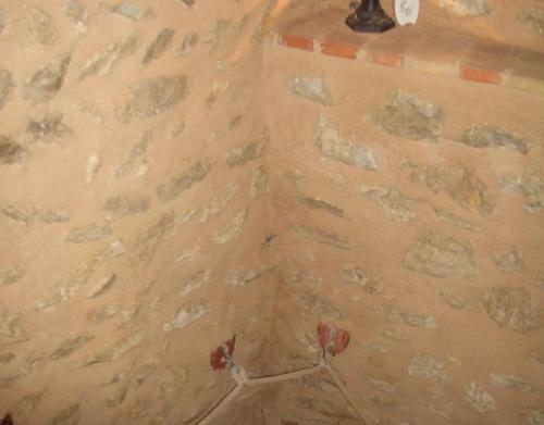 a corner of a room with a stone wall at Casa Gimeno in Bocairent