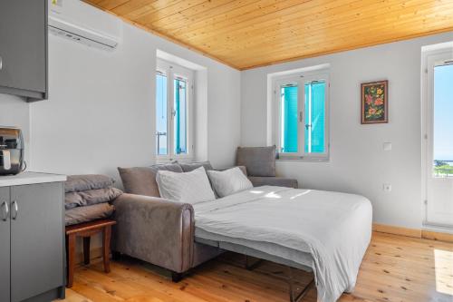 a living room with a couch and a table at Milia's House Ithaca in Vathi