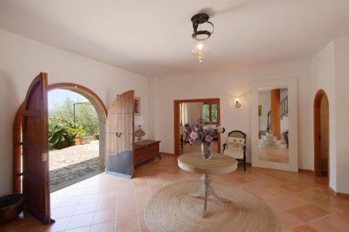 a living room with a table and a chair at Sa Corbaia Nova in Artá