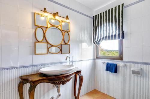 a bathroom with a sink and a mirror at Sa Corbaia Nova in Artá