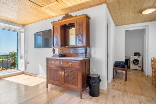 a large wooden cabinet in a living room at Milia's House Ithaca in Vathi