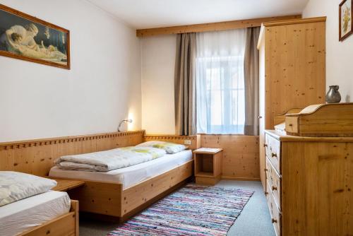 a bedroom with two beds and a window at Haus Thurn Apartment B in Castelrotto