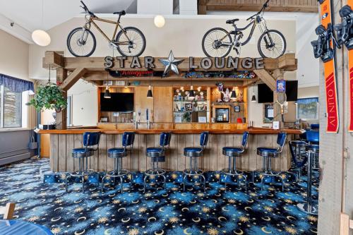 a bar with two bikes on the wall at North Star Lodge & Resort in Killington