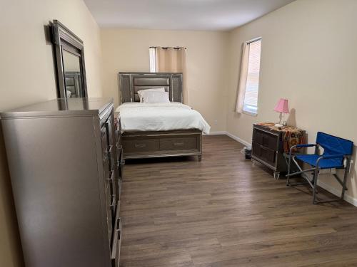 a bedroom with a bed and a desk and a chair at Blessed Homes in East Orange