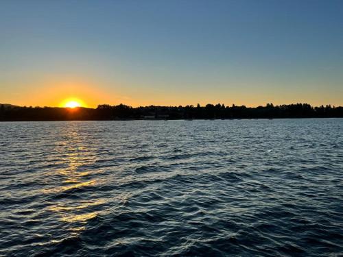 a sunset over a large body of water at Ferienwohnung Seeglück in Moos