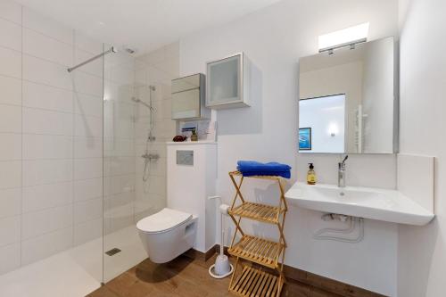 a bathroom with a sink and a toilet and a shower at Chambres D'hôtes Sous Le Pin in Les Sables-d'Olonne