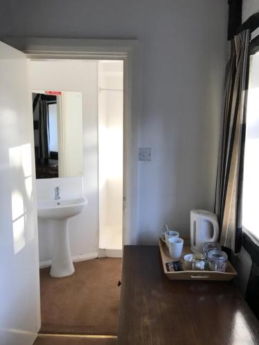 a bathroom with a sink and a toilet at The Bulls Head Inkberrow in Inkberrow