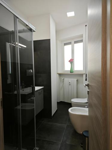a bathroom with a sink and a toilet and a shower at DeMarchi in Biella