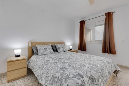 a bedroom with a large bed and a window at Edificio El Baifo Loco - Milena in Gran Tarajal