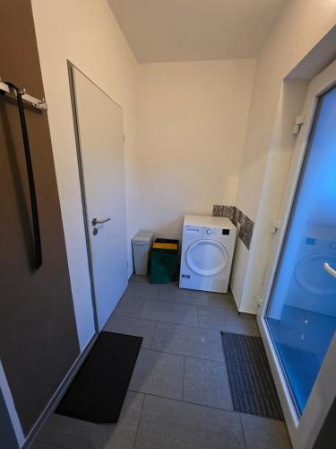 a small bathroom with a toilet and a door at Relax after work in Ochsenhausen
