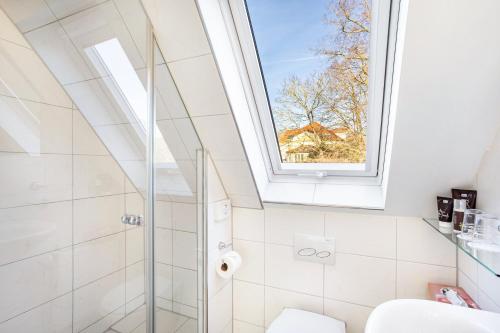 a bathroom with a shower and a skylight at Casa Felicitas Fewo und Studio in Möhnesee