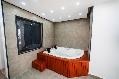 a bathroom with a bath tub and a window at Villa Ocak 1 in Kaş