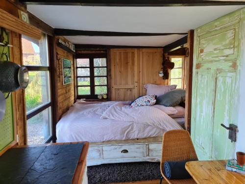 a bedroom with a bed in a wooden room at Pepper Huis in Lemgo