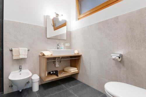 a bathroom with a sink and a toilet at Thusnelda Apartment D in Siusi