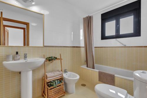 a bathroom with a sink and a toilet at Villa Asensio in Lajares
