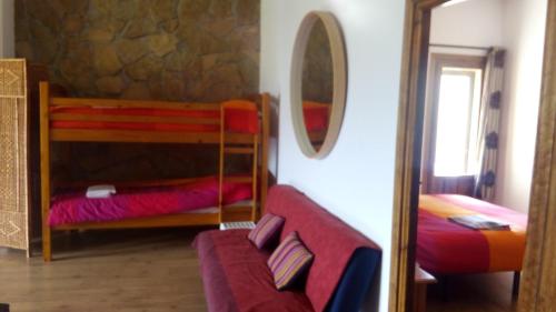 a bedroom with two bunk beds and a mirror at Cortijo la Era in Castril