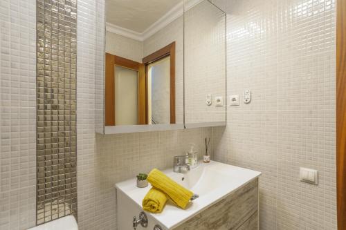 a bathroom with a sink and a mirror at Welcome To The Relax Zone in Los Caideros