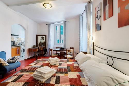 a bedroom with a bed and a living room at Lisettarooms in Vernazza
