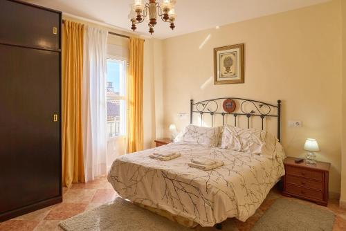 a bedroom with a large bed and a window at Casa Romo 2 in Rute
