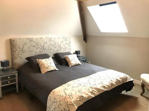 a bedroom with a bed with two pillows on it at Moulin De La Benatre in Entrammes