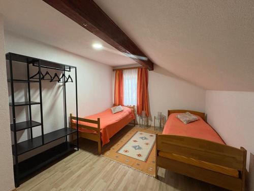 a bedroom with two beds and a window at Bugojno Avantura in Donjići
