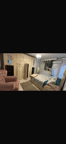 two pictures of a bedroom with a bed and a couch at Pyramids & GEM Tourist Apartment in ‘Ezbet `Abd el-Ḥamîd