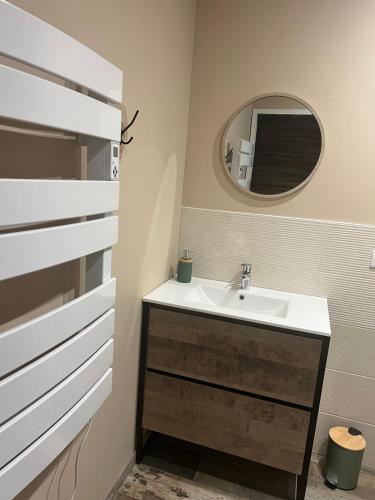 a bathroom with a sink and a mirror at La Cure Vosgienne in Champdray
