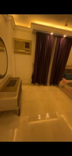 a bathroom with a tub and a sink and a mirror at Pyramids & GEM Tourist Apartment in ‘Ezbet `Abd el-Ḥamîd