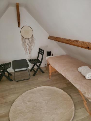 a living room with a couch and a chair at Chalet Honfleur in Honfleur
