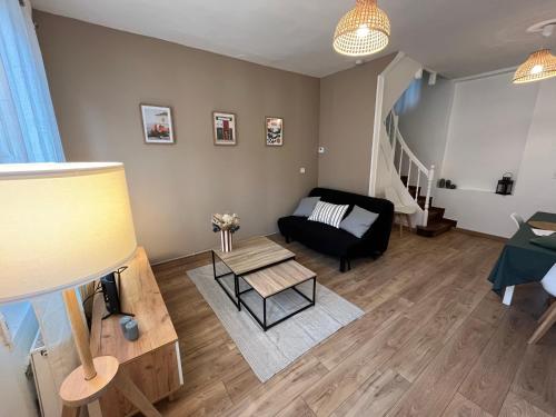 a living room with a couch and a table at Maison Delavigne in Amiens