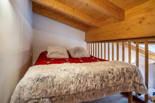 a bedroom with a bed in a room with wooden ceilings at Condominio Lucia 12 Pinzolo in Pinzolo