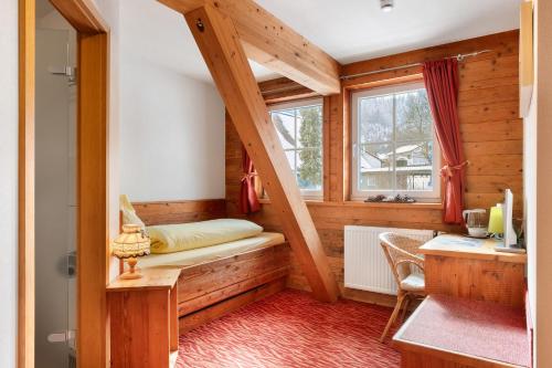 a small room with a bed and a window at Gästehaus Krone in Sankt Georgen im Schwarzwald