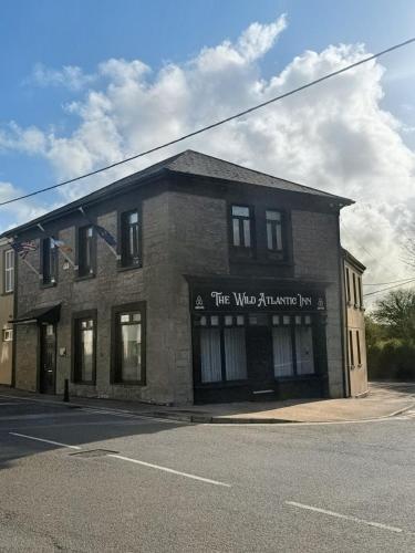 a brick building with a sign on the front of it at Wild Atlantic Inn in Lisdoonvarna