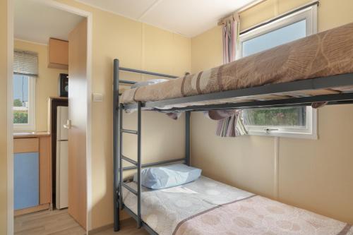a bedroom with two bunk beds and a window at Calma in Barbate