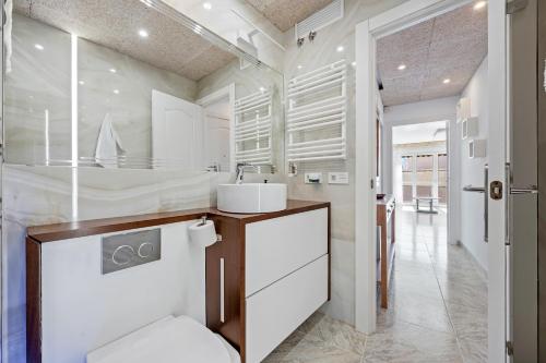 a bathroom with a sink and a toilet at Apartment with spa and bbq in El Vendrell